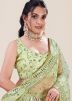 Green Sequins Embellished Saree In Net